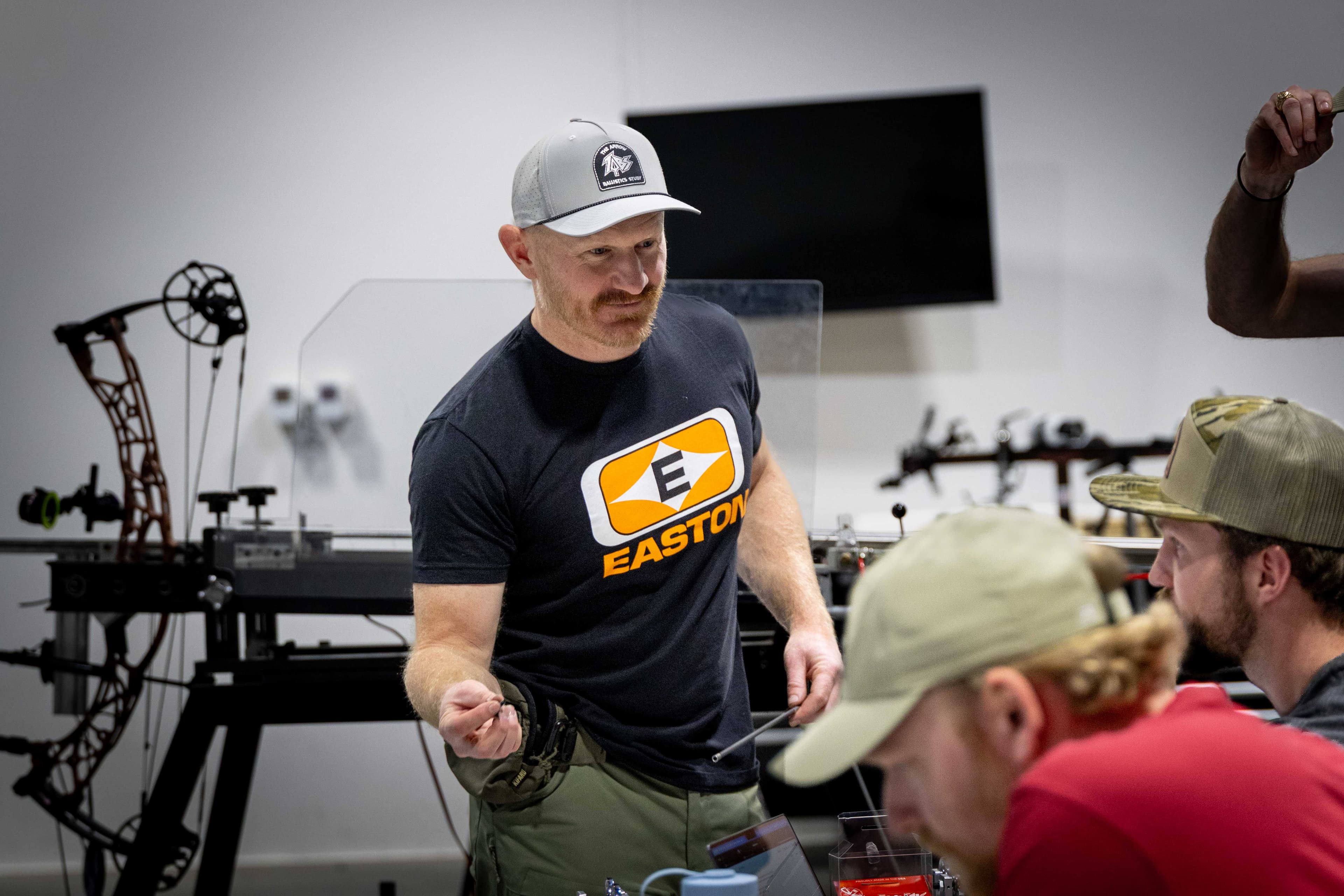 Team members in conversation between test sets at the Easton lab