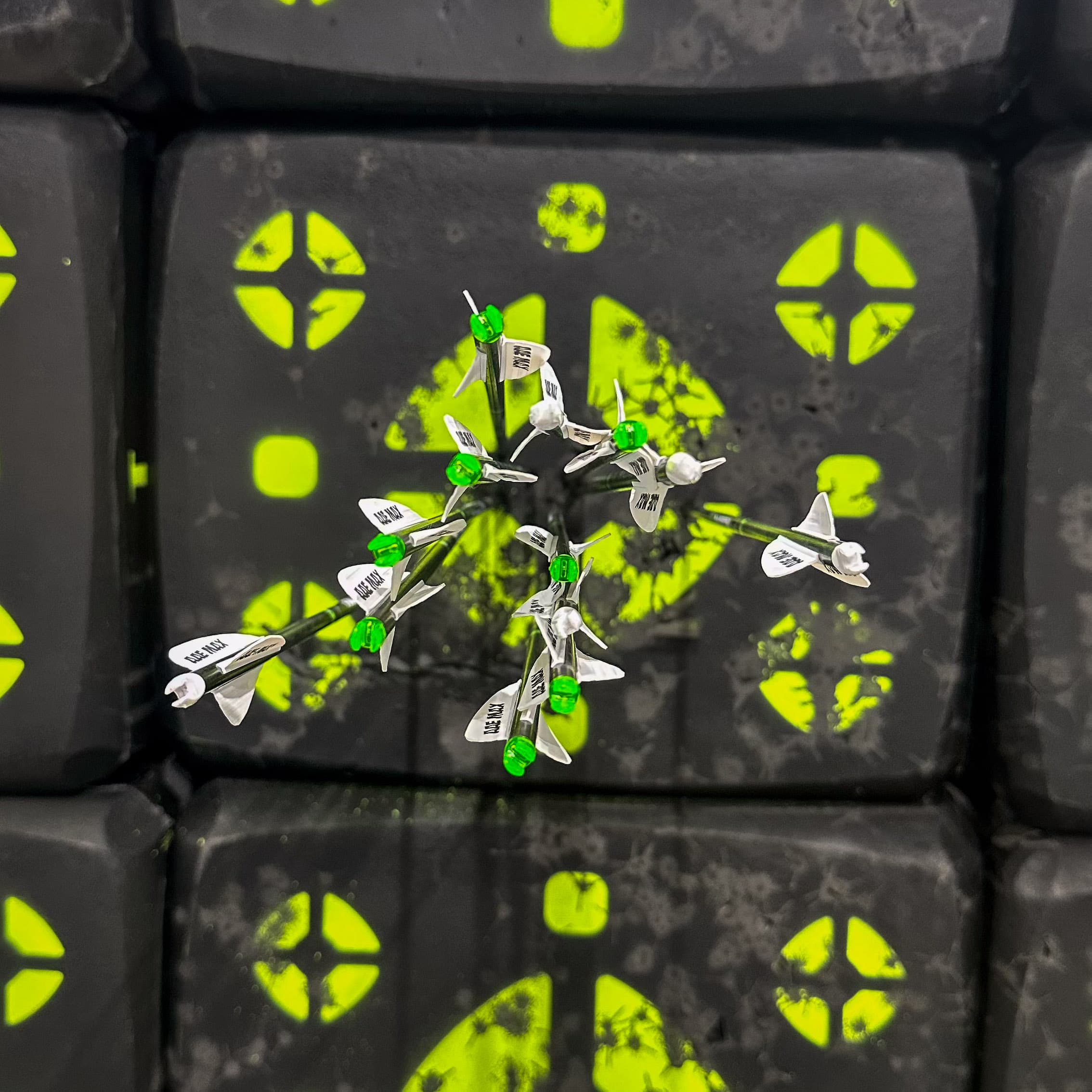 Arrow group on a paper target before squaring the nock end of the arrows